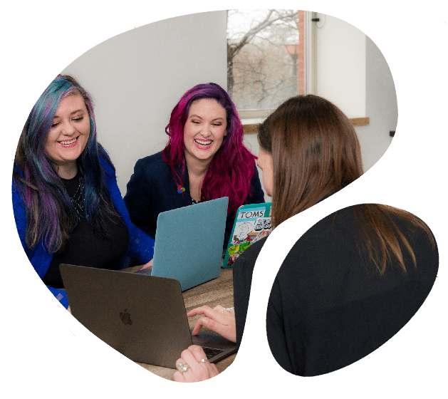 Three women collaborating and smiling