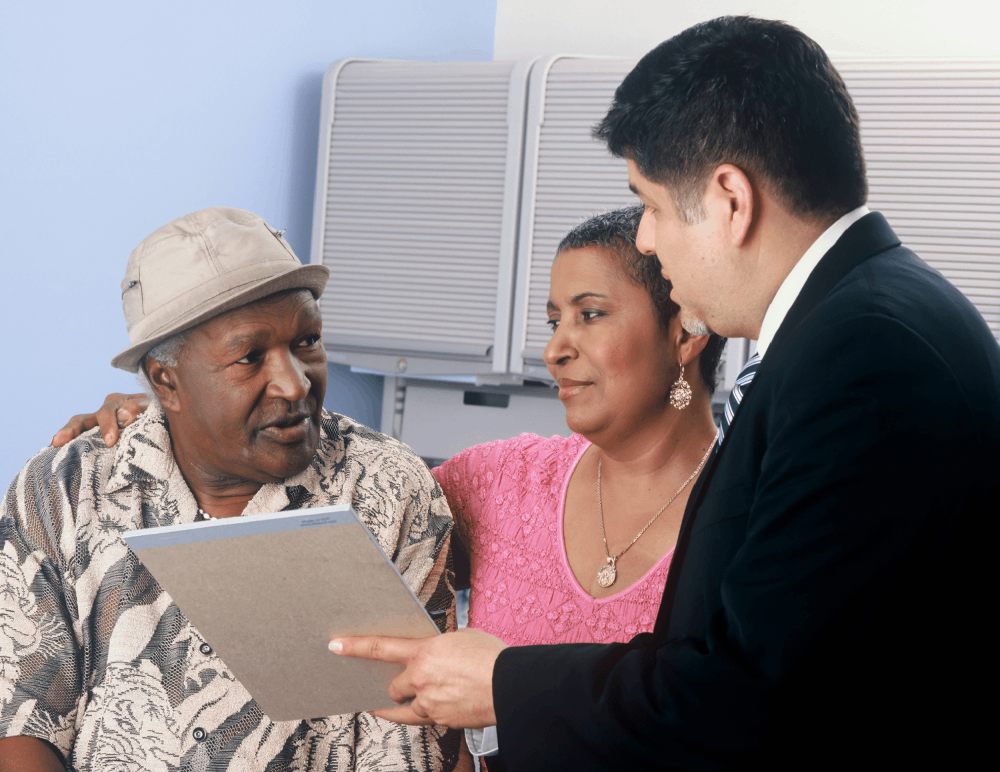 Three people discussing a document